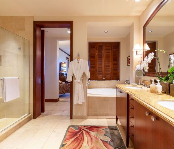 The image features a luxurious bathroom with a shower, bathtub, wooden accents, and elegant decor, creating a serene ambiance.